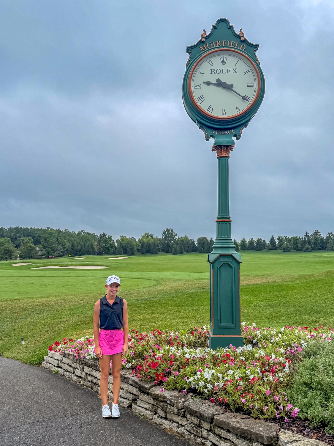Olivia Huffman standing beside the Muirfield Village Golf Club clock during the PGA Junior Championship on July 28, 2026